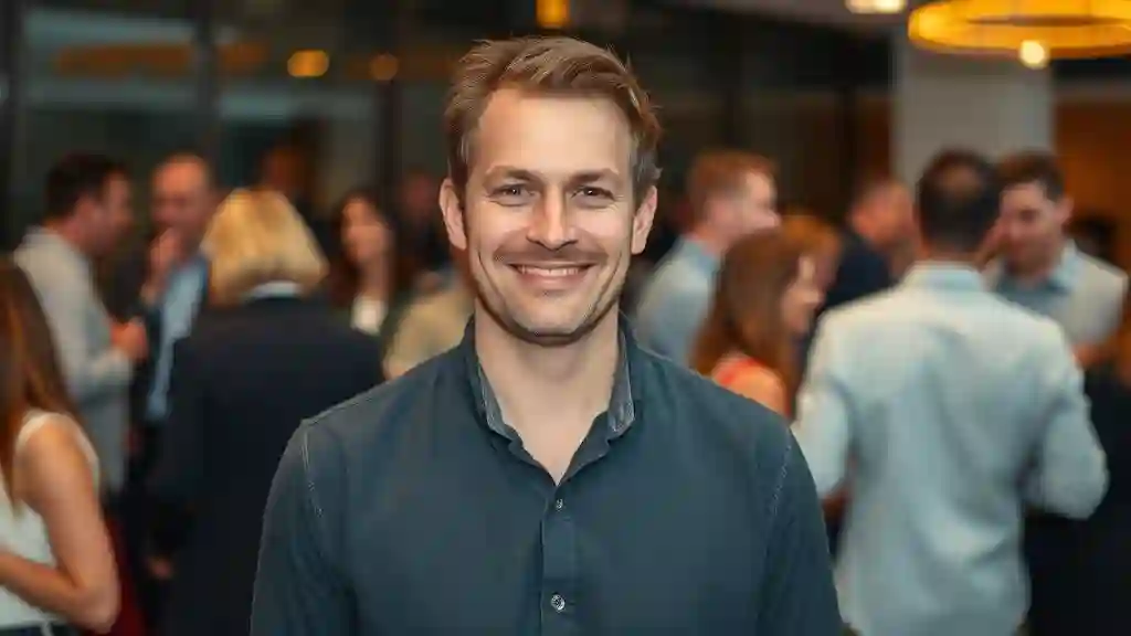 “Man standing calmly and confidently in a group, showing quiet self-assurance.”